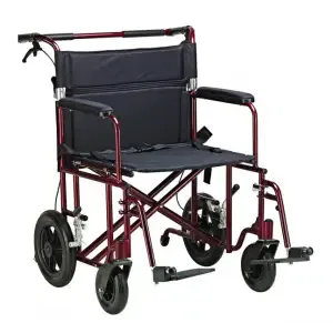 XL bariatric transport chair being pushed along a beachfront walkway in Hawaii, designed for assisted mobility and higher weight capacity.